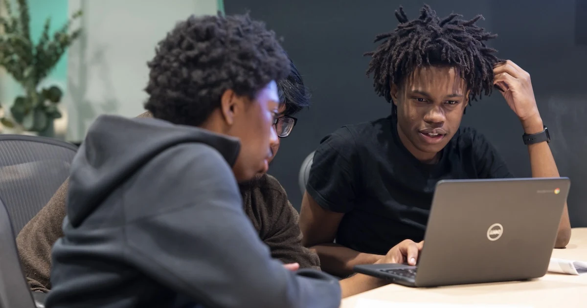 A photo of individuals participating in Coded by technology and coding programs.